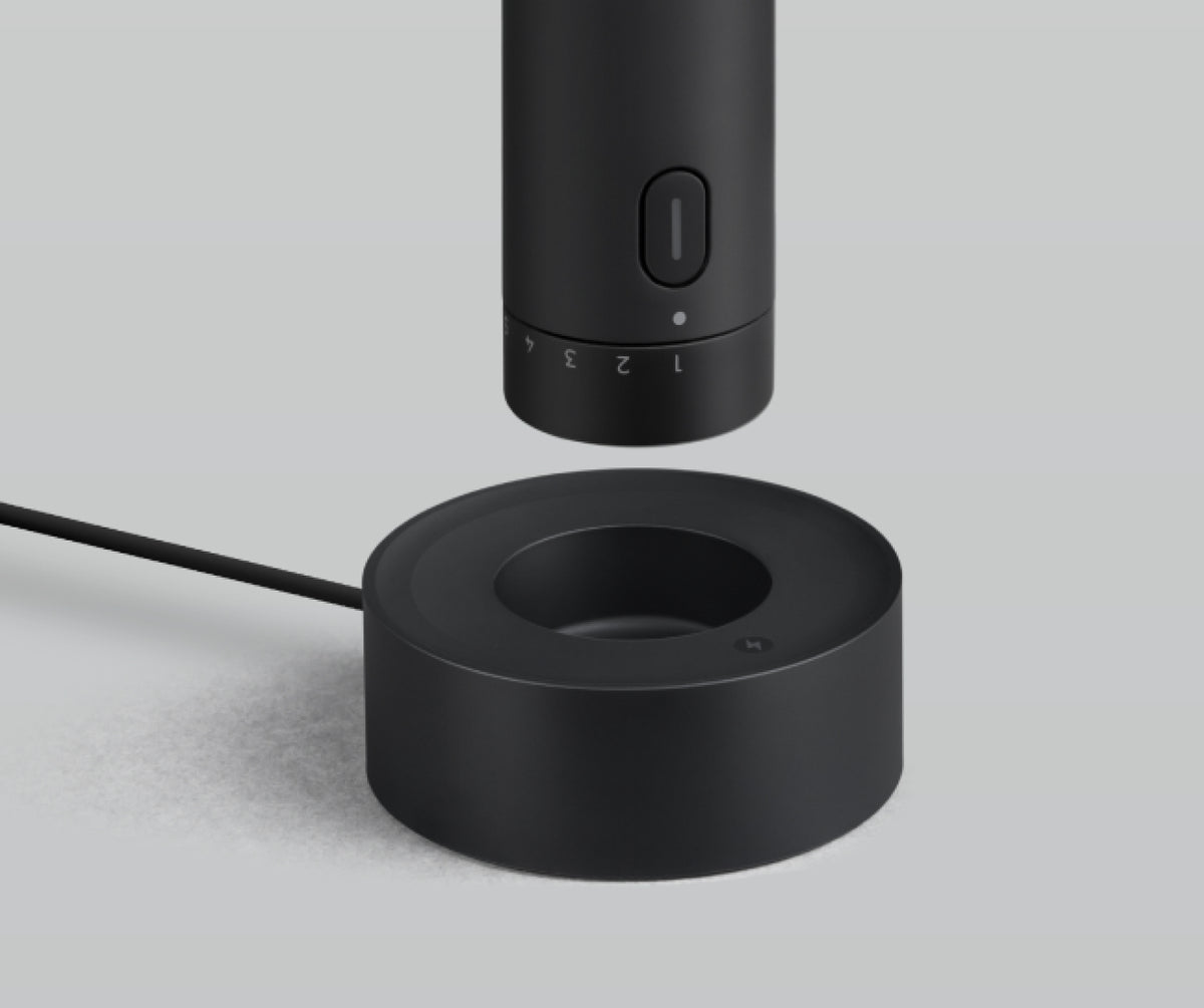 HOTO 4V Rotary Tool positioned above its USB-powered charging and storage dock