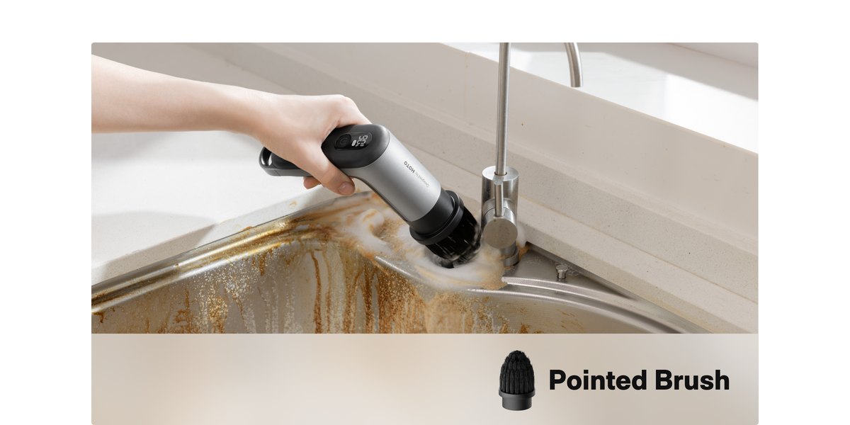Pointed brush reaching a narrow corner around a kitchen sink