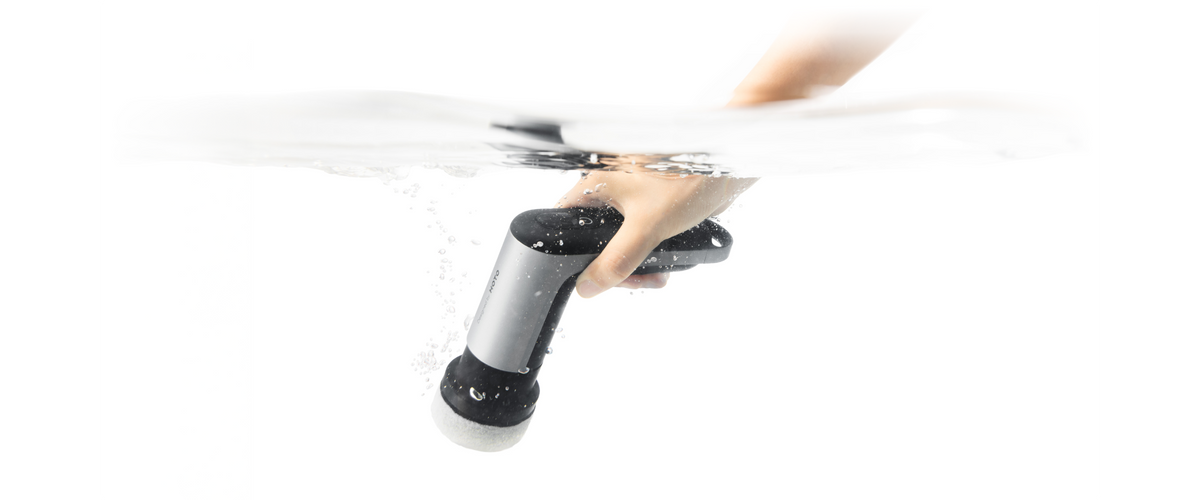HOTO Grip IPX7 waterproof spin scrubber being rinsed under water